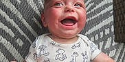 Malakye joined the competition — help win amazing prizes! animal_print, baby, cheerful, child, cute, fabric, face, hand, happy, head, indoors, infant, lying_down, onesie, patterned_clothing, person, skin, smiling, texture, young_child