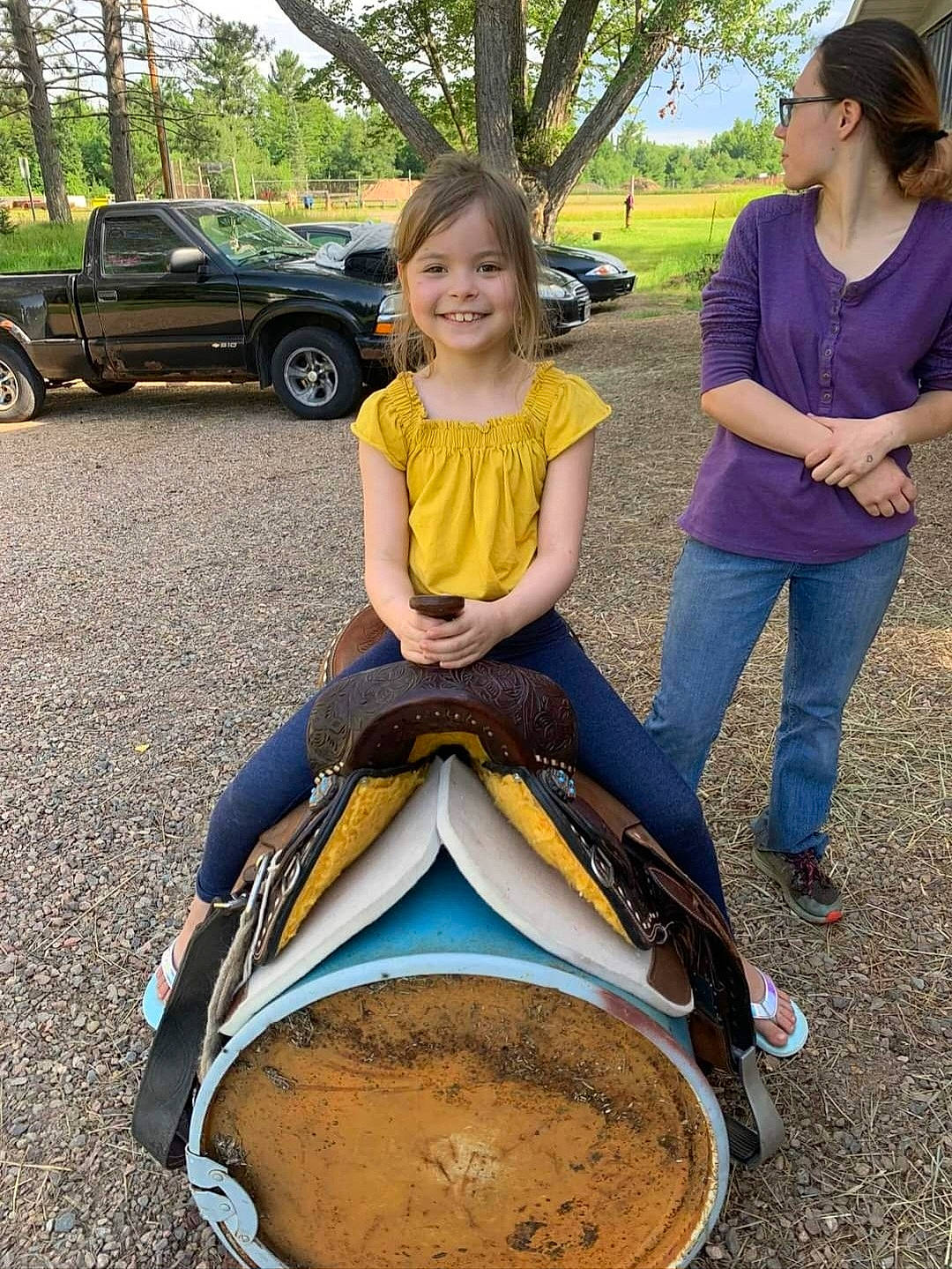 Layla is registered to the contest to win money with this photo: automotive_design, automotive_exterior, automotive_tire, car, fun, grass, happy, joy, leisure, mammal, motor_vehicle, people, person, plant, shoe, smile, sneakers, tire, tree, vehicle