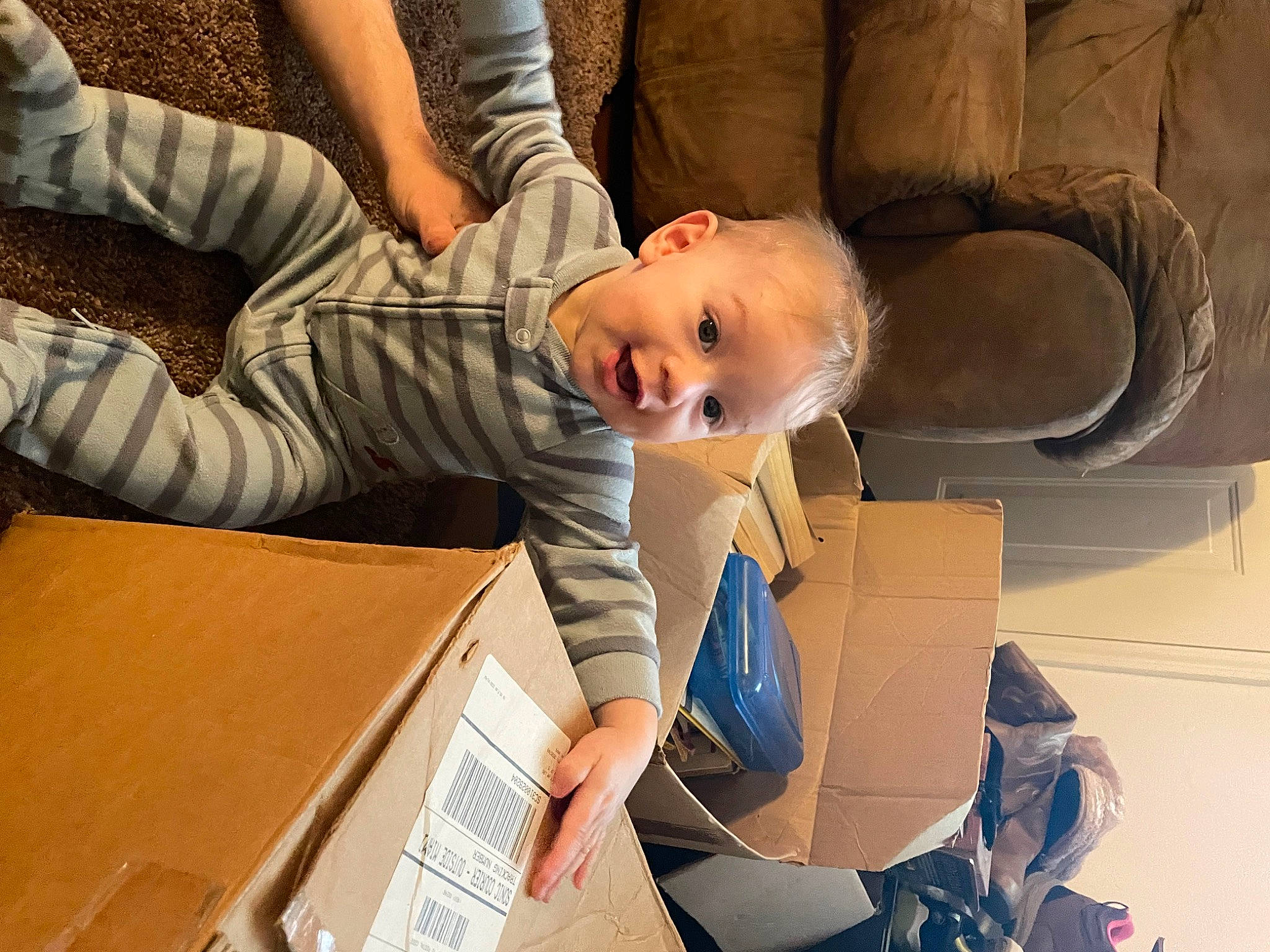 Paul is registered to the contest to win money with this photo: auto_part, automotive_design, baby, box, carton, chair, child, comfort, couch, eye, fun, happy, luxury_vehicle, person, room, shipping_box, sitting, smile, suit, toddler