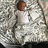 Lj joined the competition — help win amazing prizes! baby, infant, pacifier, blanket, patterned_blanket, clothing, onesie, pants, animal_print, bed, sleepwear, lying_down, infant_clothing, cute, soft_texture, indoor, person, baby_girl_or_boy, relaxed, calm