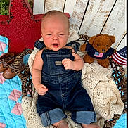 Brooks is registered to the contest to win money with this photo: baby, infant, child, portrait, sitting, swing, denim_overalls, crocheted_blanket, teddy_bear, american_flag, red_star, shoes, quilt, outdoor, wooden_background, rustic, cozy, serious_expression, feet, photography