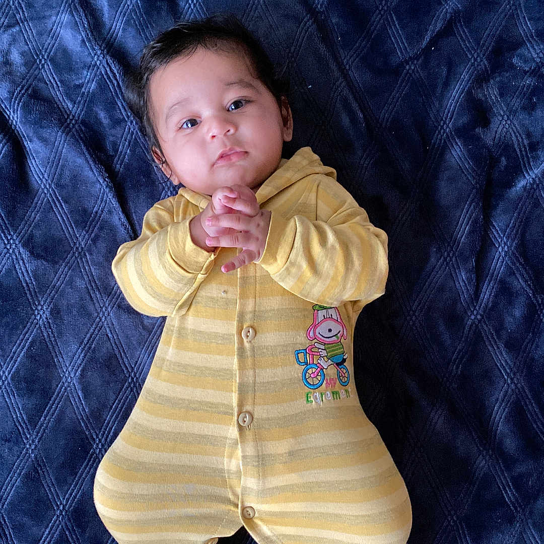 Rajaram is registered to the contest to win money with this photo: applique, baby, blanket, bodypart, clothing, face, finger, glove, hand, head, knitwear, longsleeve, newborn, pajamas, pants, person, photography, portrait, sleeve, sweater