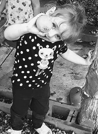 Skarlett is registered to the contest to win money with this photo: arm, baby, black, black_and_white, child, fun, gesture, grass, hairstyle, hand, happy, monochrome, monochrome_photography, people_in_nature, person, photograph, smile, standing, style, toddler