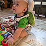 baby, child, toys, playmat, plush_turtle, backpack, indoor, floor, person, adult, sitting, colorful, curious, cute, crawling, patterned, happy, playtime, clothing, family