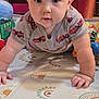 baby, child, crawling, play_mat, toy, frog_toy, onesie, red_fire_truck, indoor, curious, wide_eyes, innocent, patterned_mat, colorful_toys, soft_lighting, closeup, person, infant, cute, playtime