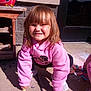 child, pink_hoodie, sidewalk, chalk, outdoor, smile, sunlight, play, drawing, concrete, casual_clothing, happy, girl, young, crouching, daylight, fun, colorful, toy, recess