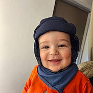 Luka participe au concours pour gagner de l'argent avec cette photo : baby, child, smiling, hat, scarf, orange_jacket, indoor, face, happy, closeup, person, cute, warm_clothing, portrait, cheerful, infant, headgear, apparel, baby_clothes, young_child