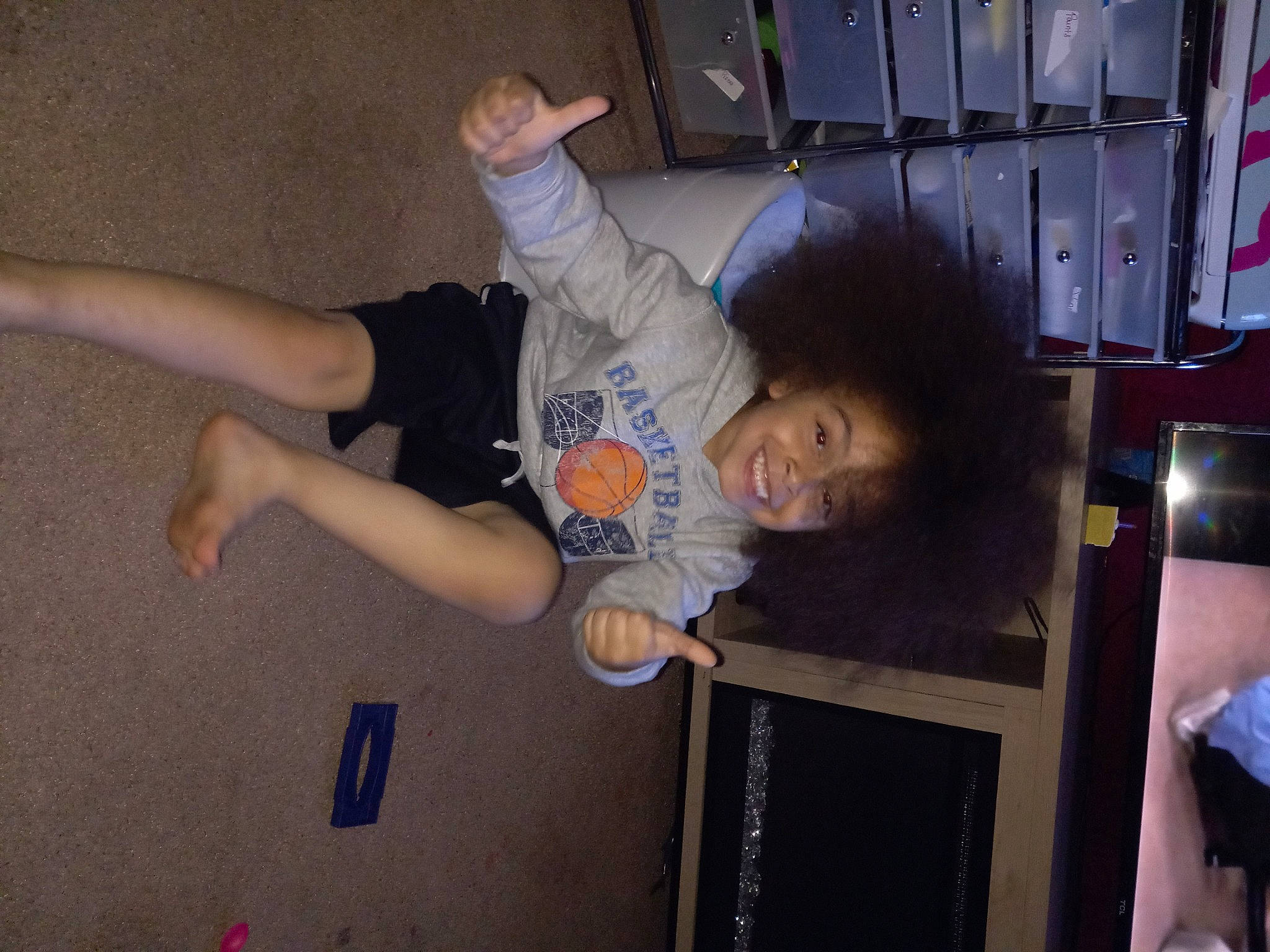 Edwin is registered to the contest to win money with this photo: adventure, balance, ceiling, child, elbow, fun, gesture, happy, human_leg, joint, joy, knee, leisure, person, play, room, shorts, sportswear, standing, t_shirt