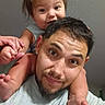 Ransom is registered to the contest to win money with this photo: arms, baby, beard, carrying, child, family, father, feet, gray_shirt, hair, hands, happy, indoor, man, parent, portrait, selfie, shoulders, smiling, wall