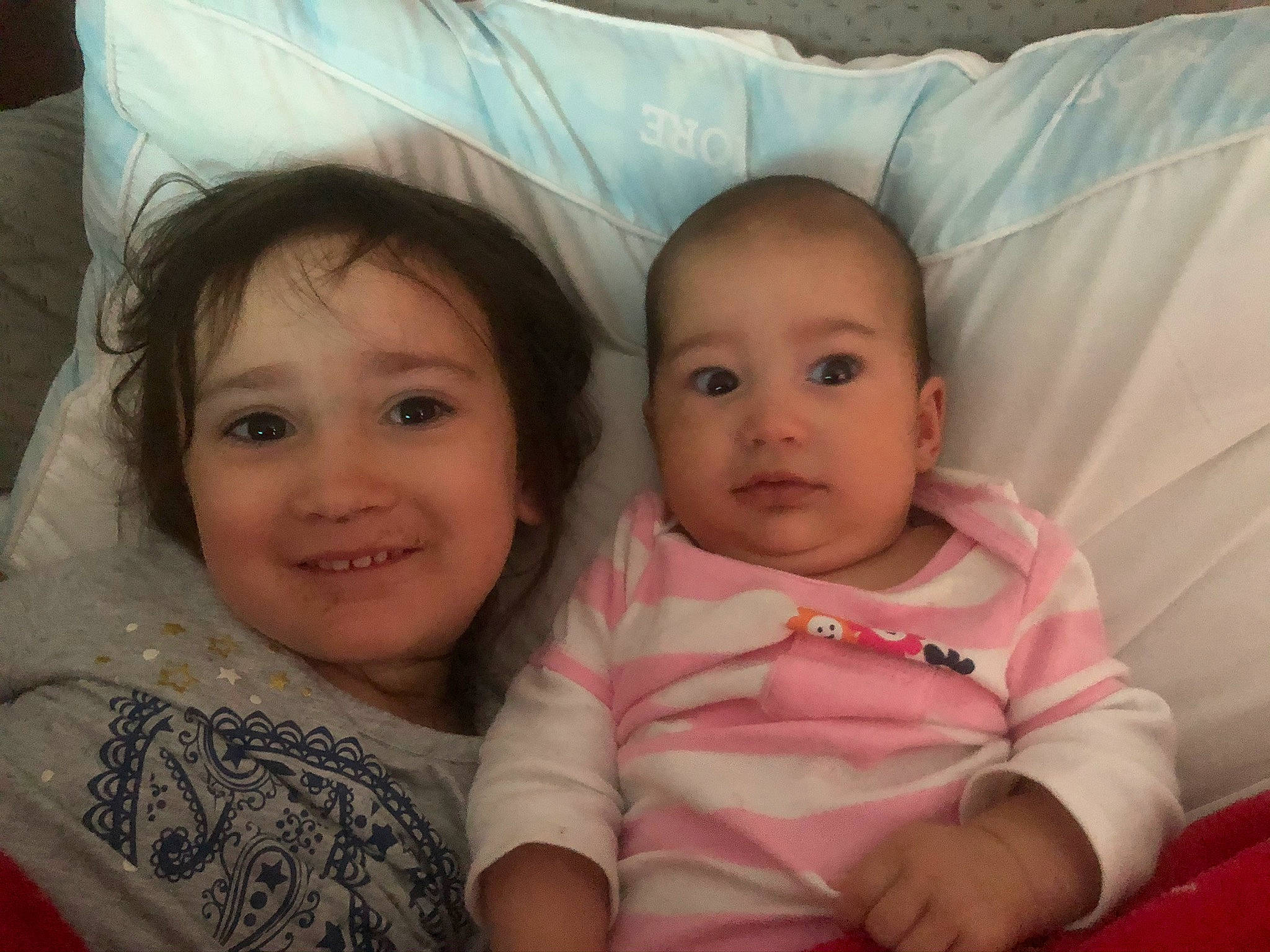 Avery is registered to the contest to win money with this photo: baby, bed, cheek, child, cousin, eye, face, family, fun, happy, head, headwear, iris, joy, lip, nose, people, person, pink, sibling