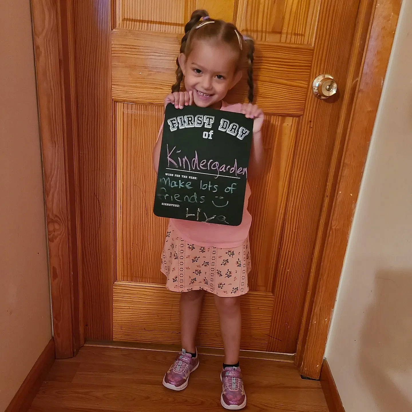 Liya is registered to the contest to win money with this photo: baby_toddler_clothing, door, fashion_design, flooring, fun, hair, happy, hardwood, joy, knee, magenta, pattern, person, room, sleeve, smile, sock, t_shirt, toddler, varnish