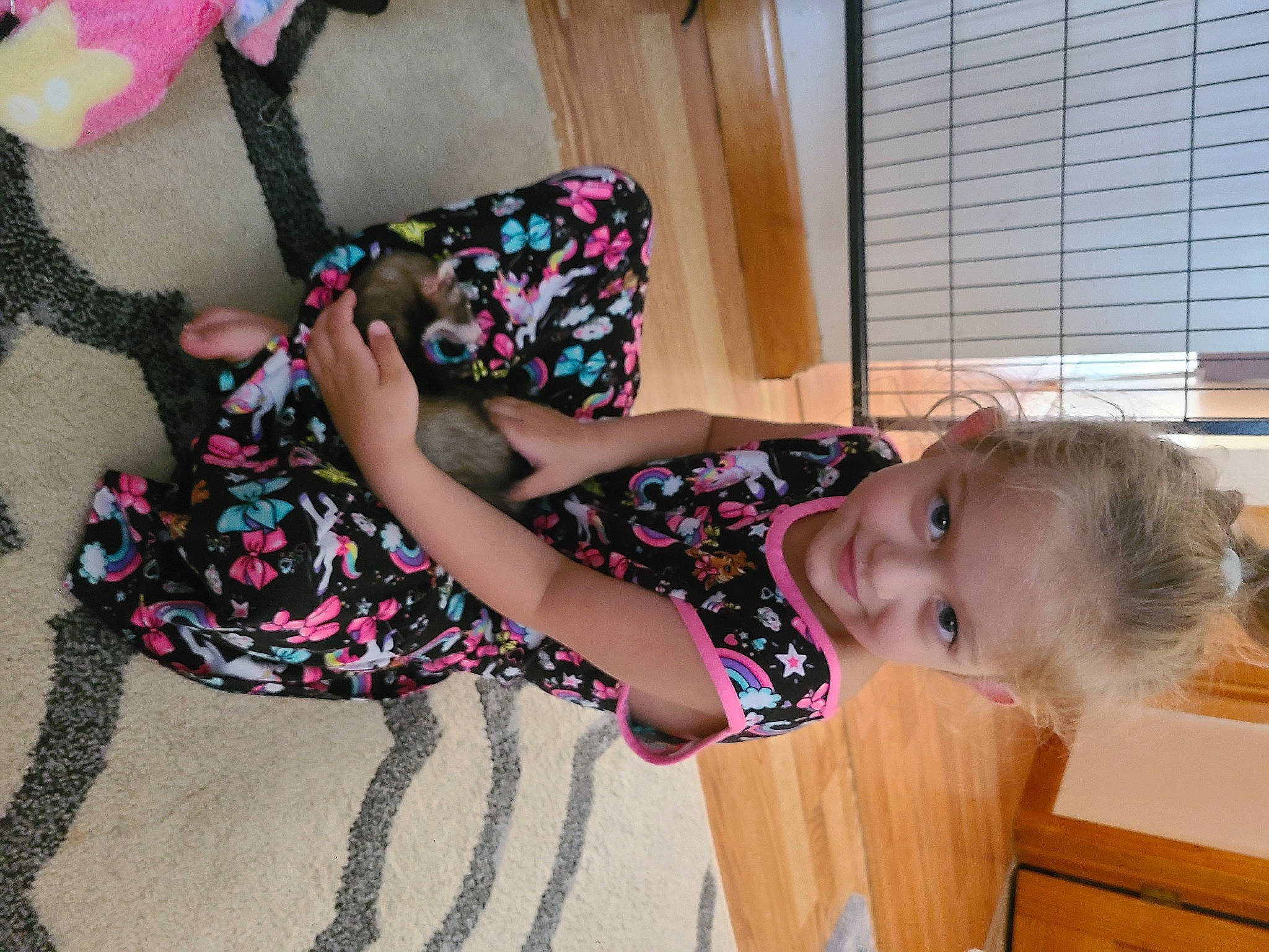 Liya is registered to the contest to win money with this photo: child, comfort, finger, floor, flooring, fun, head, human_body, human_leg, joint, joy, knee, pattern, person, pink, skin, smile, sock, thigh, toddler