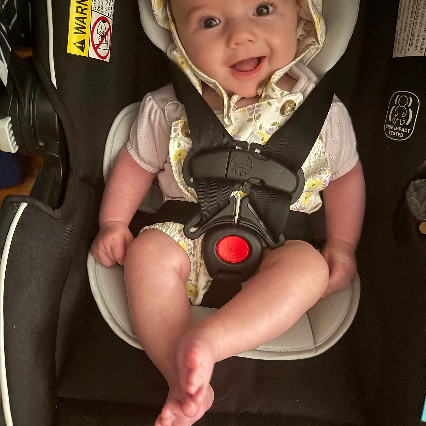 Kenedee is registered to the contest to win money with this photo: baby, child, car_seat, smile, happy, straps, safety, bonnet, infant, cute, clothing, seat, closeup, person, young_child, cheerful, indoors, comfort, secured, portrait