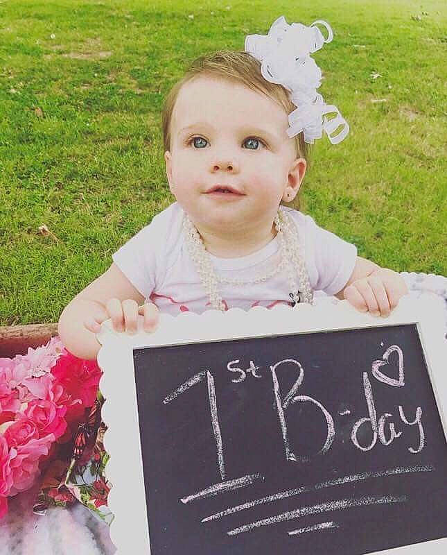 Addison is registered to the contest to win money with this photo: child, day, girl, hair_accessory, happiness, material, person, petal, photograph, pink, play, product, smile, toddler