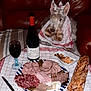Manny participe au concours pour gagner de l'argent avec cette photo : baguette, charcuterie, cheese, cozy, dining, dog, food, indoor, knife, leather_couch, mandarin_slices, meat_slices, pet, pickles, snack, tablecloth, towel, walnuts, wine_bottle, wine_glass
