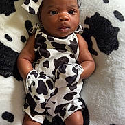 Marlaya joined the competition — help win amazing prizes! baby, baby_fashion, baby_outfit, black_and_white, blanket, bow, clothing, cow_print, cute, fabric, headband, infant, lying_down, mittens, newborn, pattern, person, portrait, skin, soft