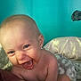Kinsley is registered to the contest to win money with this photo: baby, blanket, blue_wall, cheerful, child, closeup, cute, expression, face, happy, head, indoor, infant, joy, person, pillow, room, skin, smiling, soft
