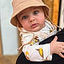 Léo a rejoint le concours — aidez-le/la à gagner de superbes lots ! baby, child, hat, bucket_hat, face, eyes, clothing, animal_print, hand, person, portrait, cute, infant, holding, warm_colors, indoor, closeup, expression, soft_focus, casual_wear