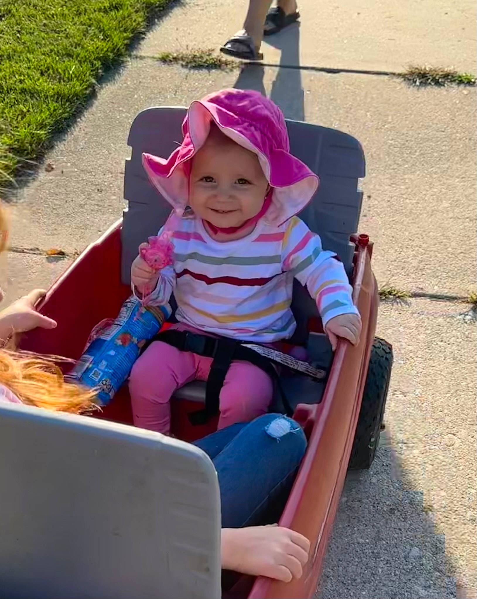 Maleah is registered to the contest to win money with this photo: baby, baby_products, baby_toddler_clothing, child, fun, grass, happy, hat, headwear, joy, leisure, magenta, outdoor_recreation, person, personal_protective_equipment, photograph, play, recreation, sitting, smile