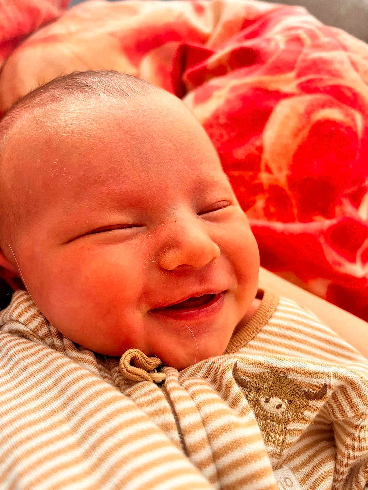 Piper is registered to the contest to win money with this photo: baby, smile, closeup, face, infant, striped_clothing, blanket, soft_light, cute, happy, newborn, warm, cozy, portrait, child, sleepy, young, skin, head, person