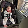 toddler, child, car_seat, vehicle_interior, gas_station, gas_pump, window, seatbelt, clothing, happy, smiling, hair, pigtails, hands, feet, car, seat, daylight, casual, baby