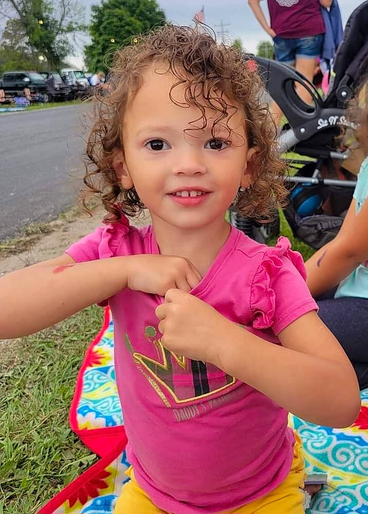 Samone is registered to the contest to win money with this photo: child, event, facial_expression, fun, grass, happy, joy, leisure, magenta, party, people_in_nature, person, pink, play, recreation, shorts, skin, smile, t_shirt, toddler