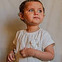 Chloé participe au concours pour gagner de l'argent avec cette photo : child, close_up, curious_expression, cute, earrings, flower_applique, girl, green_eyes, hands, indoor, innocence, neutral_background, person, photography, portrait, short_hair, soft_lighting, toddler, white_dress, youth