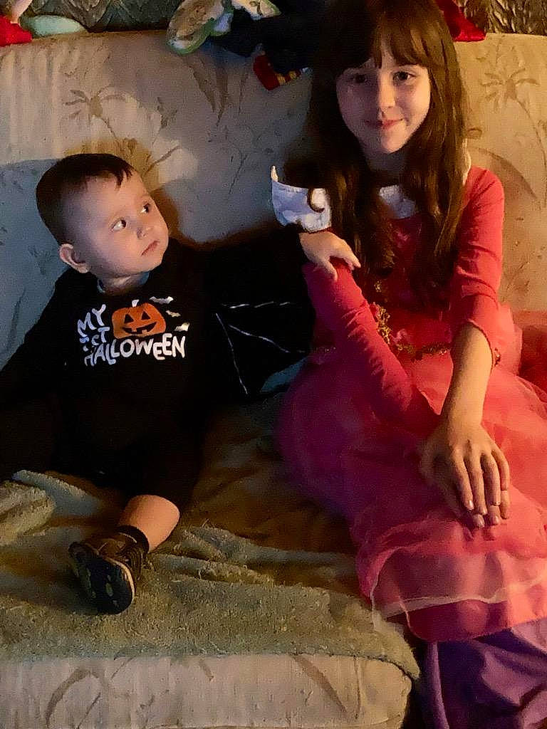 Blaize is registered to the contest to win money with this photo: bangs, child, cool, eyelash, face, fun, happy, head, human_body, human_leg, jewellery, joy, lap, leg, necklace, person, shoe, sitting, skin, sleeve