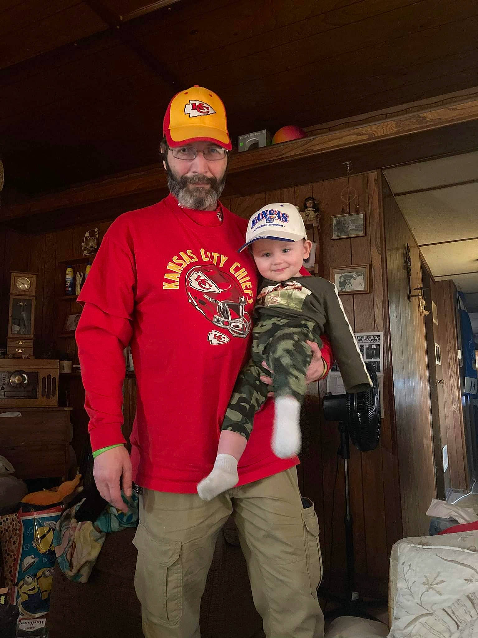 Blaize is registered to the contest to win money with this photo: baseball_cap, belt, cap, christmas, christmas_eve, event, fun, headwear, helmet, holiday, jacket, joy, lap, luggage_and_bags, person, personal_protective_equipment, room, smile, t_shirt, toddler