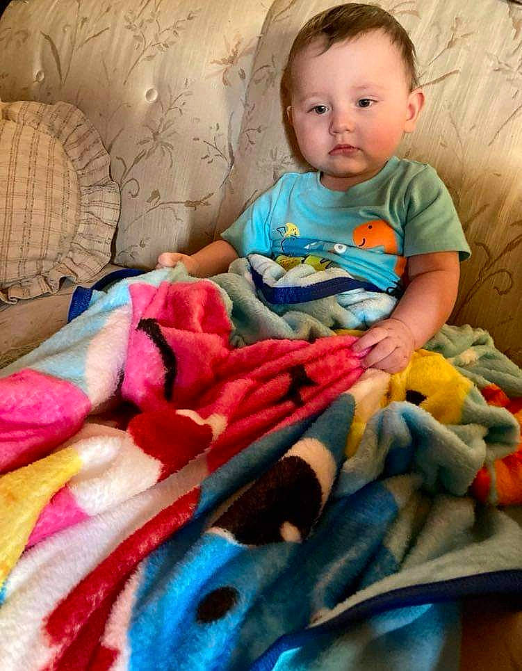 Blaize is registered to the contest to win money with this photo: baby, baby_toddler_clothing, beauty, cheek, child, comfort, eye, face, happy, head, linens, orange, pattern, person, pink, room, sitting, skin, t_shirt, textile