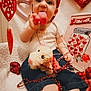 Cris is registered to the contest to win money with this photo: baby, beads, chewing, child, cute, decoration, denim_shorts, festive, headband, heart, holiday, indoor, love, plush_toy, red, sitting, stuffed_animal, toy, valentine, white_shirt