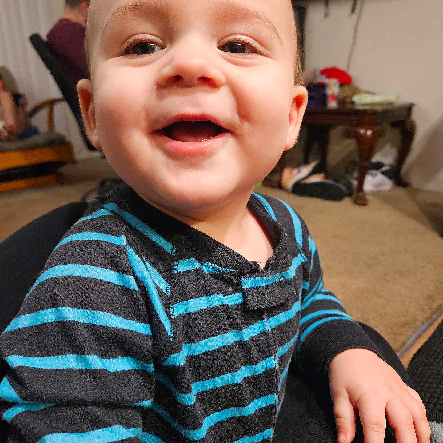 Hendrix is registered to the contest to win money with this photo: adult, architecture, baby, bodypart, building, desk, face, finger, furniture, hand, happy, head, male, man, person, photography, portrait, sitting, smile, table