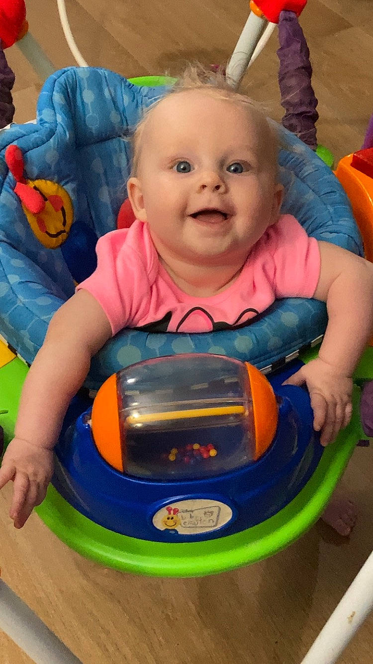 Avianna is registered to the contest to win money with this photo: baby, baby_playing_with_toys, baby_products, baby_safety, baby_toddler_clothing, baby_toys, bumper, cheek, child, fun, leisure, orange, person, play, purple, recreation, room, sitting, smile, toddler