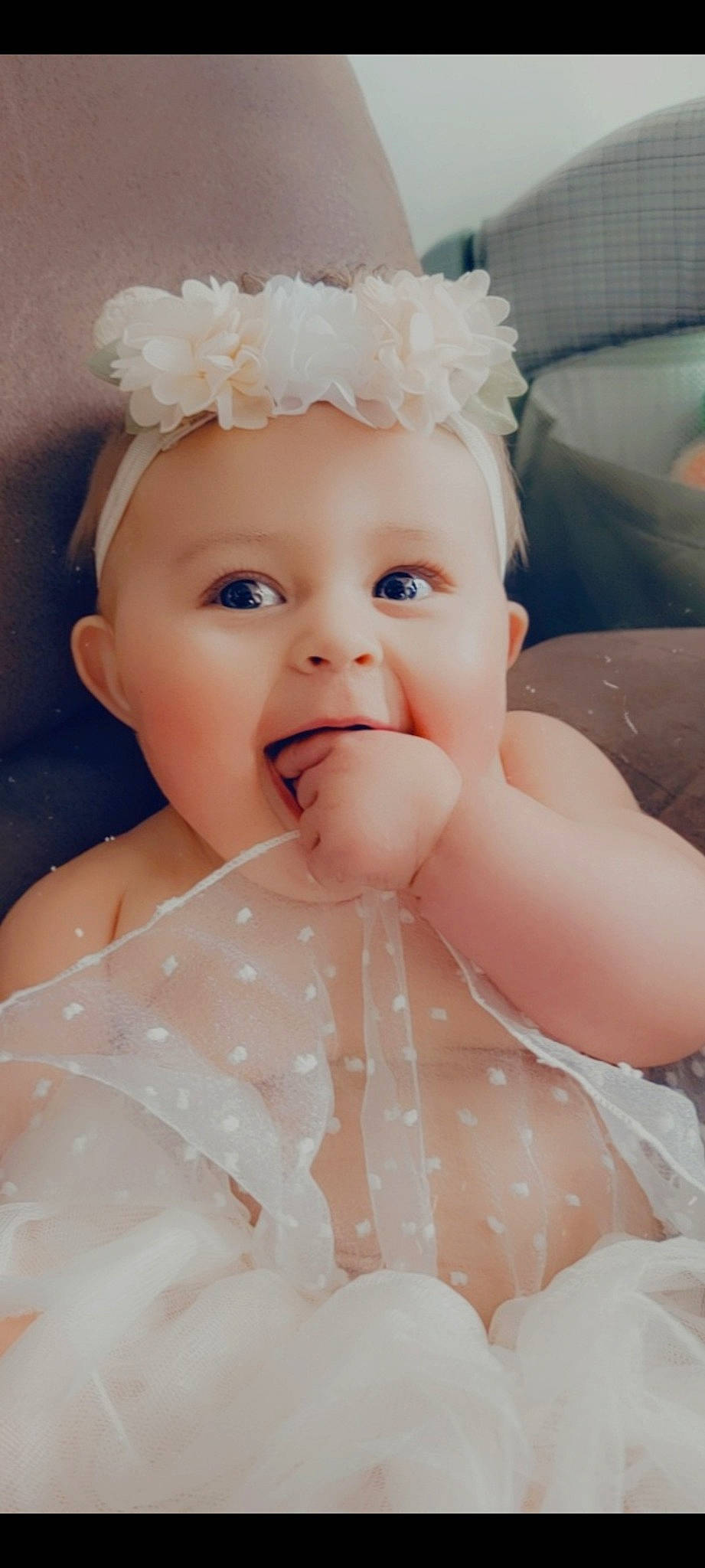 Freyja is registered to the contest to win money with this photo: baby, baby_toddler_clothing, chin, embellishment, face, finger, flash_photography, happy, head, headgear, iris, light, lip, person, pink, skin, sleeve, smile, textile, toddler