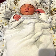 Maylonn participe au concours pour gagner de l'argent avec cette photo : baby, newborn, blanket, hat, sleeping, infant, bed, pillow, soft, cozy, child, cute, peaceful, rest, indoors, warm, hands, face, wrapped, animal_print