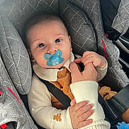 Maylonn participe au concours pour gagner de l'argent avec cette photo : baby, car_seat, child, closeup, clothing, comfort, cute, fabric, gray, hand, holding_hand, indoor, infant, pacifier, parent, person, safety, seatbelt, toddler, young_child