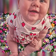 Lily-Anne is registered to the contest to win money with this photo: baby, child, clothing, colorful, cute, eyes, face, floral_background, flowers, hands, happy, indoors, infant, legs, portrait, sitting, skin, smiling, soft_lighting, strawberry_print