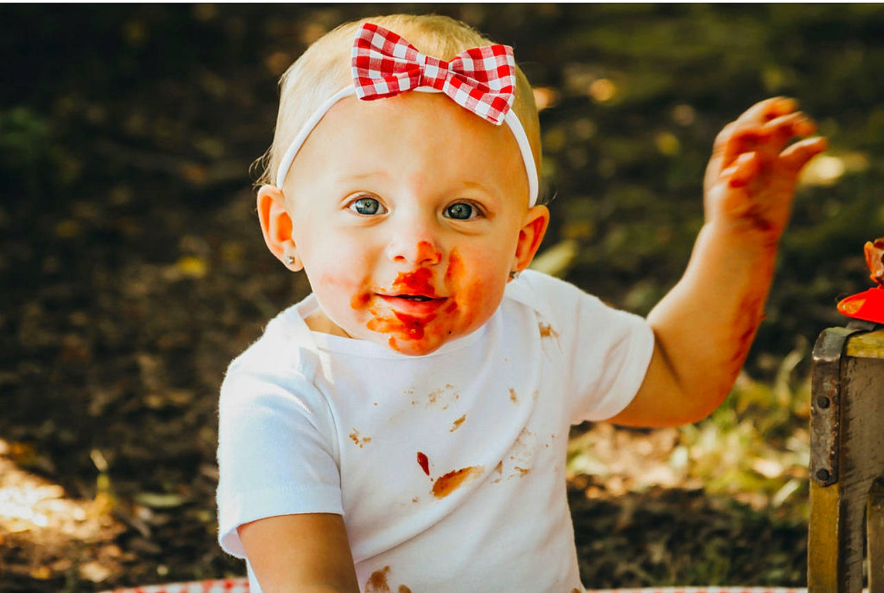 Oaklee joined the competition — help win amazing prizes! baby, baby_toddler_clothing, child, clothing, fashion_accessory, flash_photography, fun, gesture, grass, happy, headband, headpiece, headwear, leisure, orange, party_supply, people_in_nature, person, plant, smile