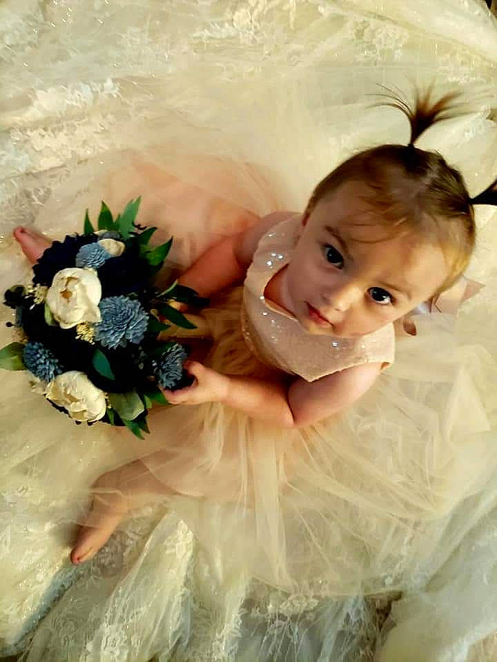 Callie is registered to the contest to win money with this photo: baby, bridal_accessory, bridal_clothing, dress, flash_photography, flower, flower_arranging, hairstyle, happy, headgear, headpiece, person, petal, pink, plant, rose, skin, smile, textile, toddler
