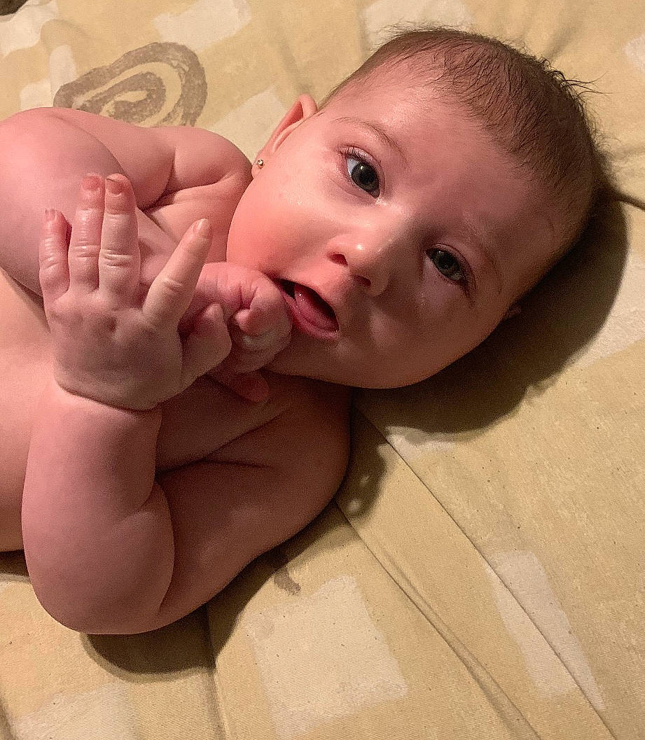 Tayler is registered to the contest to win money with this photo: arm, baby, cheek, child, chin, close_up, eye, face, finger, forehead, hand, head, leg, lip, mouth, muscle, nose, person, skin, thumb