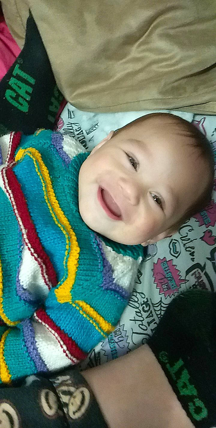 Remus is registered to the contest to win money with this photo: baby, baby_laughing, baby_toddler_clothing, cheek, comfort, eye, eyebrow, face, happy, iris, joy, lip, mouth, nose, pattern, person, product, skin, smile, textile