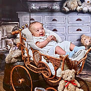 Austin is registered to the contest to win money with this photo: baby, blanket, child, cozy, cute, drawer, furniture, happy, indoor, infant, plush_toy, portrait, rustic, smiling, stroller, teddy_bear, toy, vintage, wicker, wood_floor