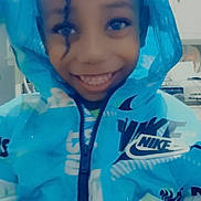 Joshua is registered to the contest to win money with this photo: child, smiling, hoodie, blue_clothing, nike, indoor, face, person, portrait, happy, hands, jacket, young_child, casual_wear, cute, fashion, closeup, apparel, childhood, playful