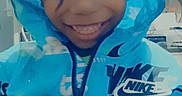 Joshua is registered to the contest to win money with this photo: apparel, blue_clothing, casual_wear, child, childhood, closeup, cute, face, fashion, hands, happy, hoodie, indoor, jacket, nike, person, playful, portrait, smiling, young_child