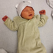 Léonie participe au concours pour gagner de l'argent avec cette photo : newborn, baby, sleeping, onesie, hat, bear_ears, blanket, infant, cozy, soft, cute, peaceful, child, resting, indoors, portrait, toddler, apparel, person, sleep