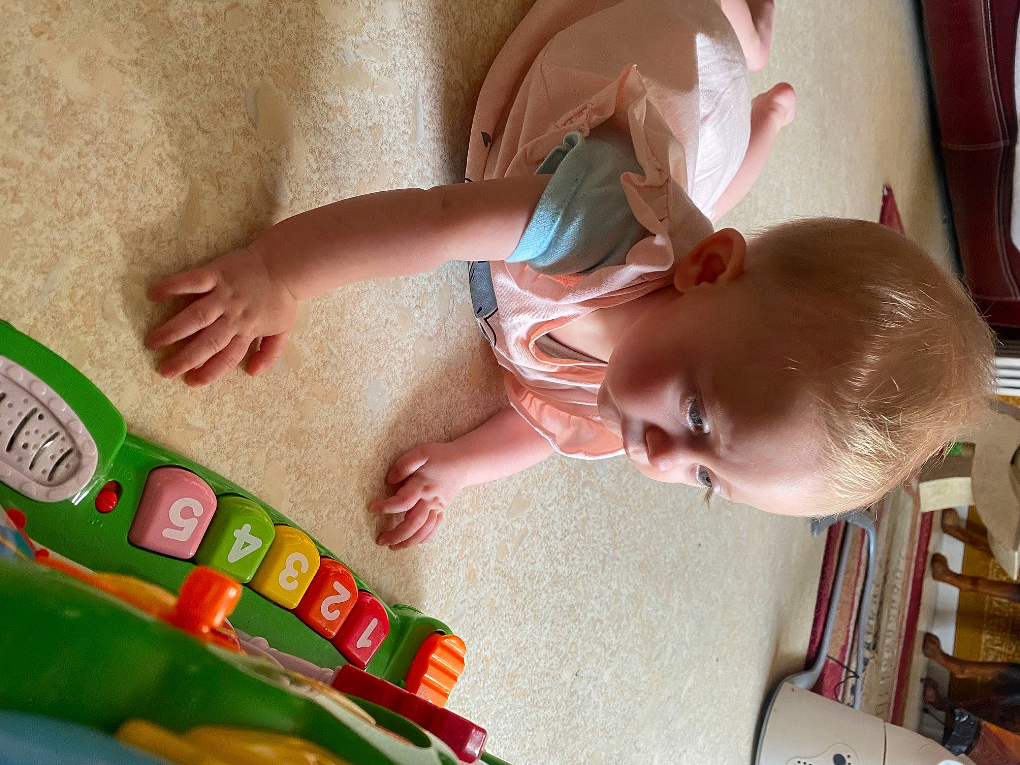 Maelys participe au concours pour gagner de l'argent avec cette photo : baby, baby_playing_with_toys, baby_products, baby_toddler_clothing, baby_toys, bookcase, child, finger, fun, holiday, nail, person, plastic, play, product, room, shelf, sitting, smile, toddler