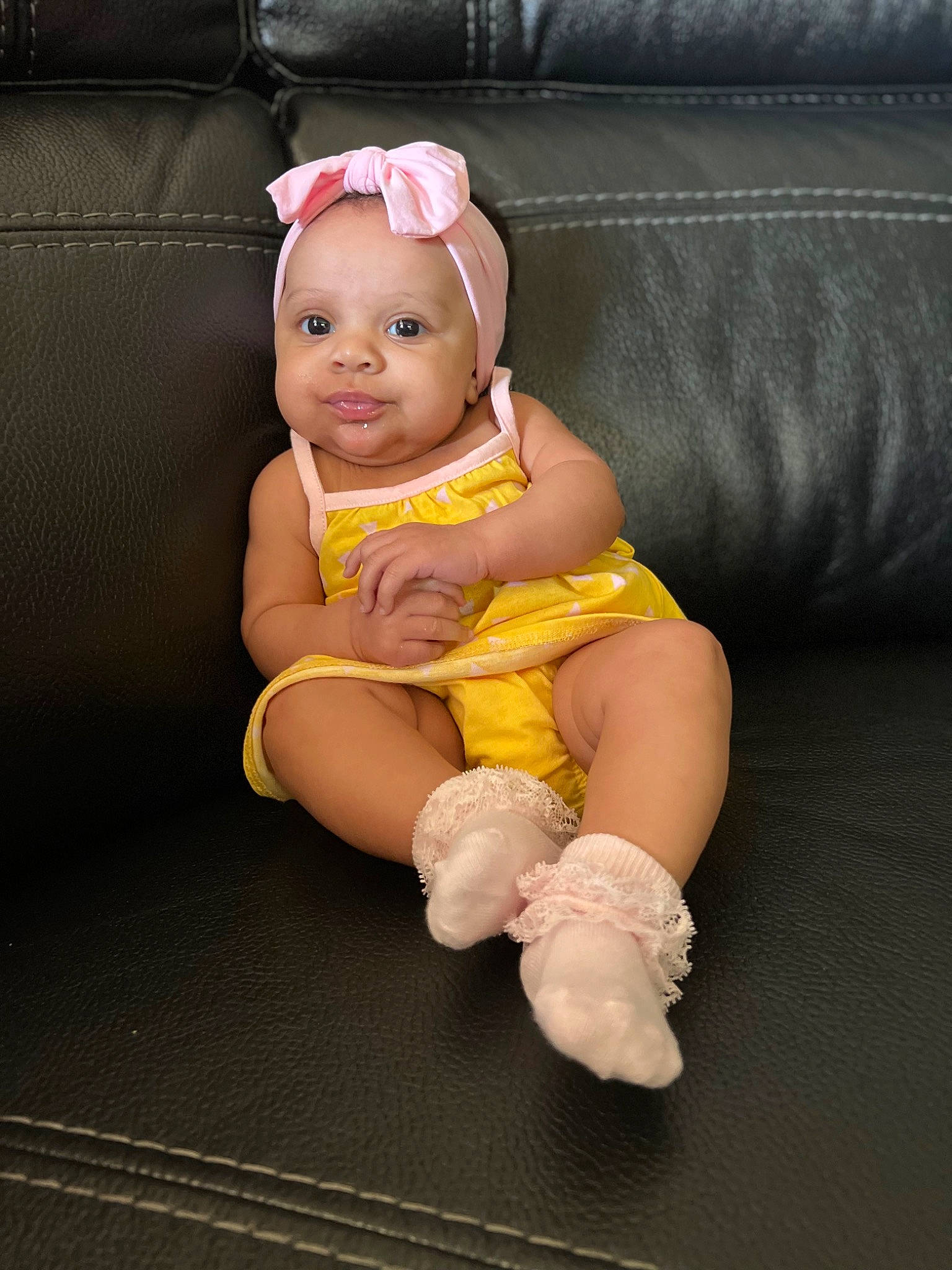 Lucia is registered to the contest to win money with this photo: abdomen, baby, baby_products, baby_toddler_clothing, chair, comfort, fashion_accessory, finger, foot, hand, headband, headwear, human_body, human_leg, knee, lap, leg, person, sock, thigh