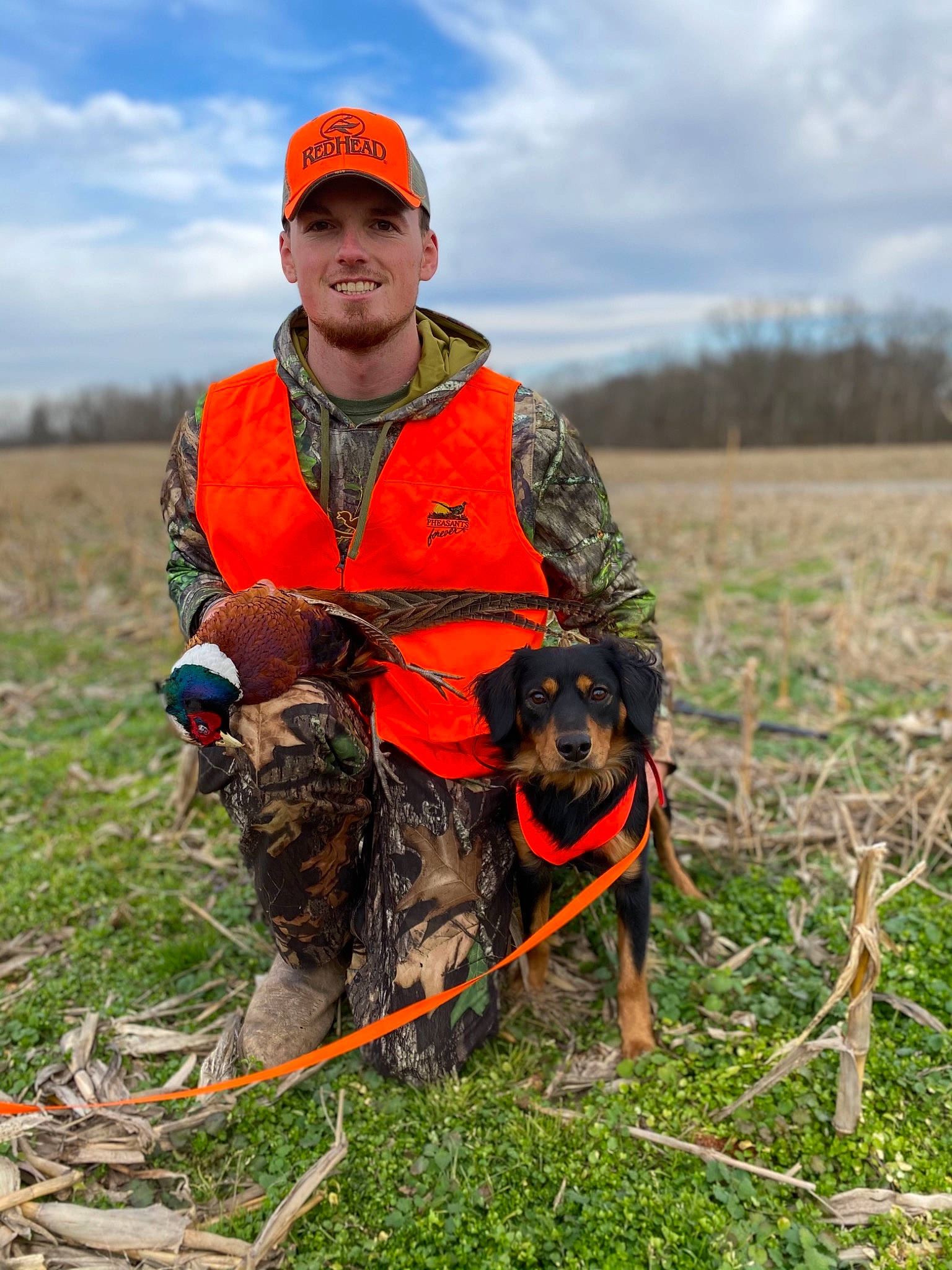 Remington joined the competition — help win amazing prizes! agriculture, baseball_cap, boot, cap, carnivore, cloud, dog, dog_breed, grass, grassland, hat, hunting, leash, plant, prairie, recreation, sky, soil, sporting_group, sunglasses