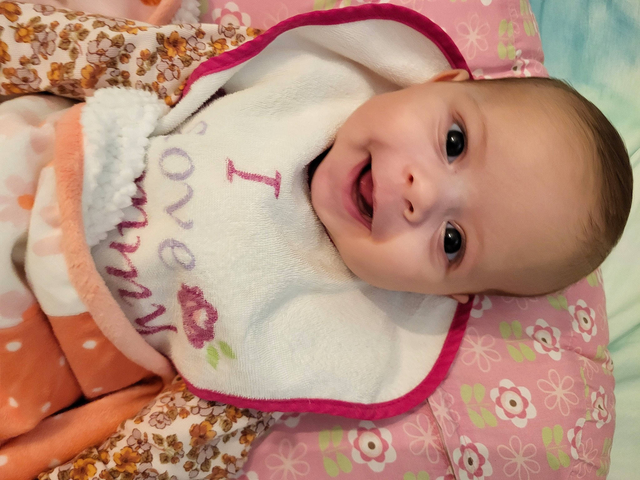 Kira is registered to the contest to win money with this photo: baby, baby_toddler_clothing, cheek, child, eyebrow, eyelash, fashion_accessory, hair_accessory, happy, headgear, human_body, iris, lip, nose, pattern, person, pink, skin, sleeve, smile