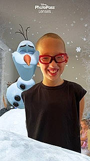 Ethan is registered to the contest to win money with this photo: animated_cartoon, animation, audio_equipment, blurred, cool, eyewear, fictional_character, fun, fur, gesture, glasses, happy, joy, person, personal_protective_equipment, sleeve, smile, standing, t_shirt, toy